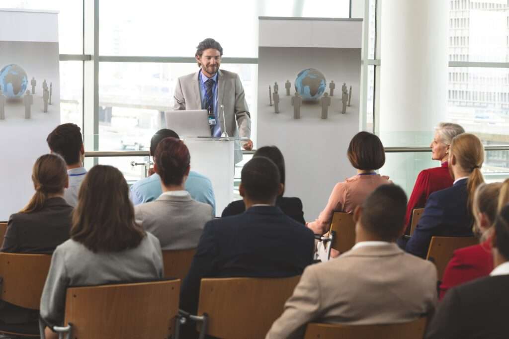 Businessman with laptop speaks at business seminar